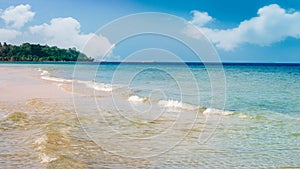 Tropical beach with soft wave and white sand summer with sunshine in relaxing vacation and outdoor nature on landscape background