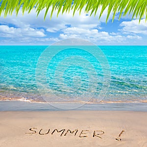 Tropical beach with Summer word written in sand