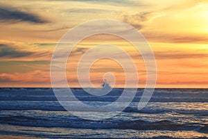 Tropical beach sunset. Empty sand beach, huge waves, and beautiful cloudy sky