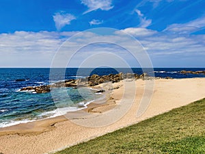 Tropical beach at sunset - nature background. Waves beat the sea foam on the sand on the beach. Beach beauty seen from the big