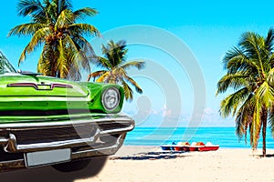 The tropical beach of Varadero in Cuba with green american classic car, sailboats and palm trees on a summer day with turquoise