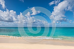 Tropical beach with white sand and turquoise water under blue sky