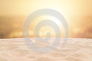 Tropical beautiful seascape view of sand beach and blurred sea with bokeh sunlight reflected on water surface in evening.