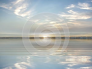 Tropical blue sunset at sea light sun reflection on ocean water white fluffy clouds at sky  beautiful nature landscape