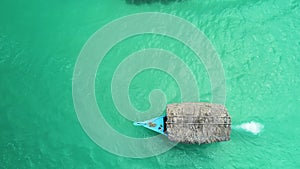 Tropical boat sailing on clear turquoise water of caribbean sea, aerial view