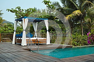 Tropical cabana and swimming pool photo