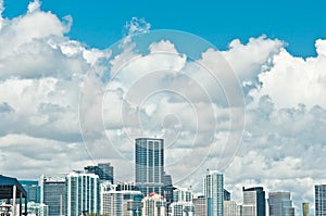 Tropical, city buildings, skyline at mid morning with shoreline clouds