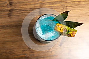 Tropical cocktails on wooden background. Frutal alcoholic cocktails. Colorful drinks concept