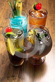 Tropical cocktails on wooden background. Frutal alcoholic cocktails. Colorful drinks concept