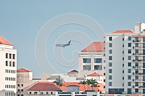 Tropical condominiums and a commercial jet liner taking off