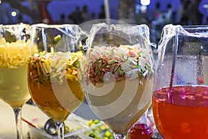 tropical drinks juice and tea with guava, citrus fruits in big glasses in vietnamese street market at night