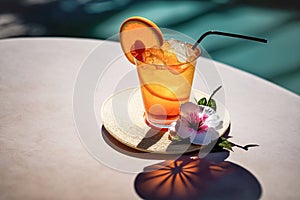 Tropical exotic cocktail in a beautiful glass with ice on the background of an outdoor pool. Summer drinks, beach