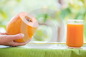 Tropical exotic papaya fruit and glass jar with smoothie shake j