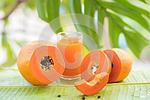 Tropical exotic papaya fruit and glass jar with smoothie shake j