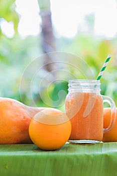 Tropical exotic pineapple and papaya fruits with jar smoothie sh