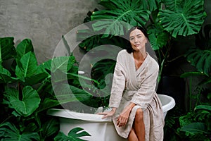 Tropical and exotic spa garden with bathtub in modern hotel or resort. Blithe