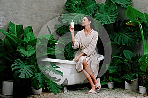 Tropical and exotic spa garden with bathtub in modern hotel or resort. Blithe