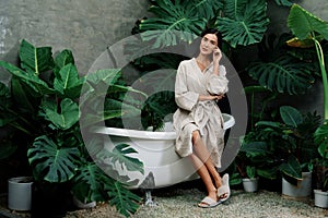 Tropical and exotic spa garden with bathtub in modern hotel or resort. Blithe