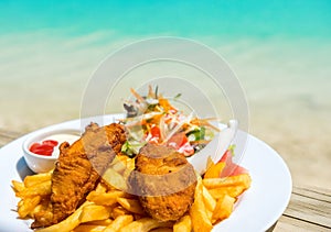 Tropical food of grilled fish, vegetables dish served on tropical island in Aitutaki lagoon, Cook Islands. With selective focus