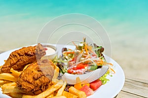 Tropical food of grilled fish, vegetables dish served on tropical island in Aitutaki lagoon, Cook Islands. With selective focus