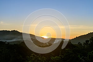 Tropical forest mountain with fog and mist in morning during sun rise at Hang Dong district in Chiang Mai, Thailand