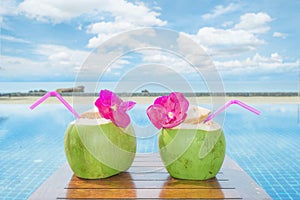 Tropical fresh coconut cocktail with pool and beach in ocean, Phuket ,Thailand