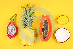 Tropical fruit flat lay on a bright yellow background