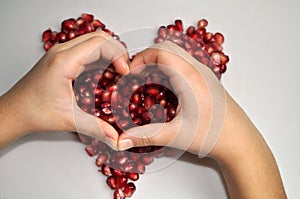 Tropical fruit - juicy, ripe red pomegranate on a white background