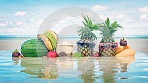 Tropical fruit mix on beach. Pineapple with sunglasses water ref