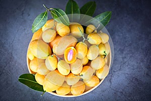 tropical fruit Name in Thailand Sweet Yellow Marian Plum Maprang Plango or Mayong chid, Marian plum fruit and leaves in plate on