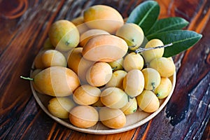 tropical fruit Name in Thailand Sweet Yellow Marian Plum Maprang Plango or Mayong chid, Marian plum fruit and leaves in plate on
