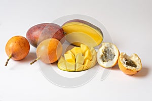 Tropical fruit salad with Mango, kiwi, passion fruit, granadilla, on white background, copy space. Delicious fruits and berries