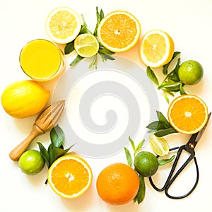 Tropical fruits for making juice of lemon, orange,lime by wooden juicer on white background. Top view. Copy space.