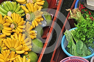 Tropical fruits and vegetables product in boat for selling at Damnoen Saduak floating market photo