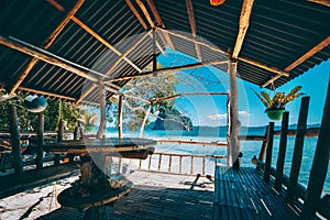 Tropical getaway remote panorama of impressive Pinagbuyutan island from the native wood and bamboo terrace, beauty of