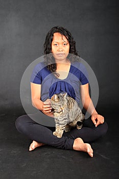 Tropical girl with tabby cat on lap