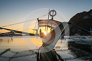 Tropical harbor bay in evening. Golden hour in lagoon in Philippines, Palawan, El Nido. Sunset on beach. Tranquil scenic