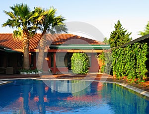 tropical house with palms and swimming pool