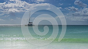 Tropical idyll. A white yacht is sailing on a calm turquoise ocean.