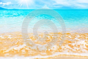 Tropical island beach nature, blue sea wave splash closeup, turquoise ocean water, yellow golden sand, sun, sky, white clouds
