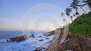 A tropical island in the Indian Ocean. Exotic seascape with coconut palms. Rocky coast of the Southern coast of the