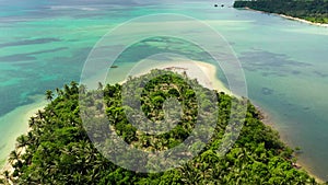 Tropical island with a lagoon and white sandy beach. Caramoan Islands, Philippines.