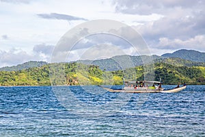 Tropical island landscape with bangca traditional philippines boats full of tourist, El Nido, Palawan