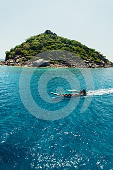 tropical island and long-tail boat