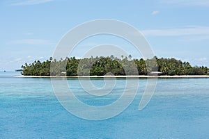 Tropical island with palm trees and huts in Tonga