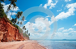 Tropical island red cliff  rock beach with blue sky and clouds in summer, tranquil serene ocean scenery. Fang Daeng in Prachuap