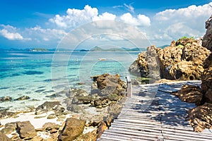 Tropical island rock and wood bridge on the beach with blue sky. Koh kham pattaya thailand