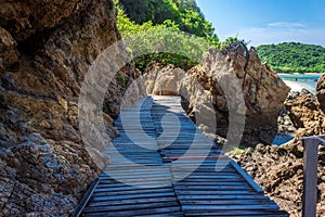 Tropical island rock and wood bridge on the beach with blue sky. Koh kham pattaya thailand
