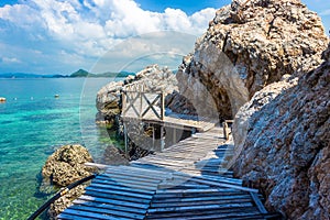 Tropical island rock and wood bridge on the beach with blue sky. Koh kham pattaya thailand