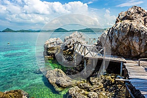 Tropical island rock and wood bridge on the beach with blue sky. Koh kham pattaya thailand